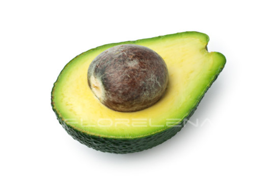 Half ripe avocado with seed isolated on white